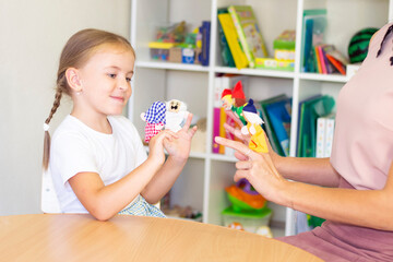 developmental and speech therapy classes with a child-girl. Speech therapy exercises and finger theater games.
