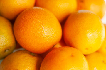 Heap of juicy oranges bathed in light