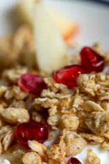 closeup of a muesli on yoghurt with pomegranate