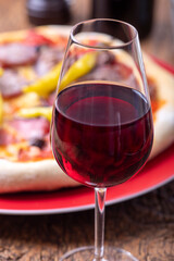 red wine and a fresh pizza