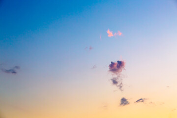 Heart-shaped cloud against a colored sky during sunset or dawn. A neat little symbol of love and a pleasant feeling.