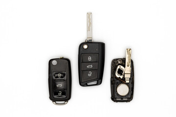 Broken or damaged remote key fob and new vehicle key on white background. Locksmith Service Concept.