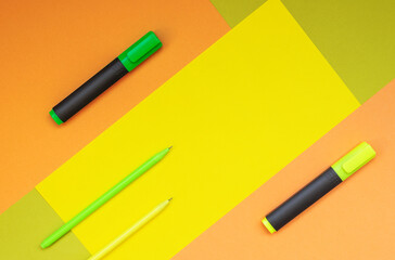 Back to school. Geometric composition of colored backgrounds and pens, markers. Pastel colors, flat lay