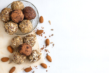 Delicious, vegetarian snack - energy balls. Homemade food made from flax seeds, sesame, Chia, peanuts and coconut paste. Top view, horizontal position, space for text on the right
