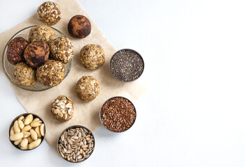 Delicious, vegetarian snack - energy balls. Homemade food made from flax seeds, sesame, Chia, peanuts and coconut paste. Top view, horizontal position, space for text on the right