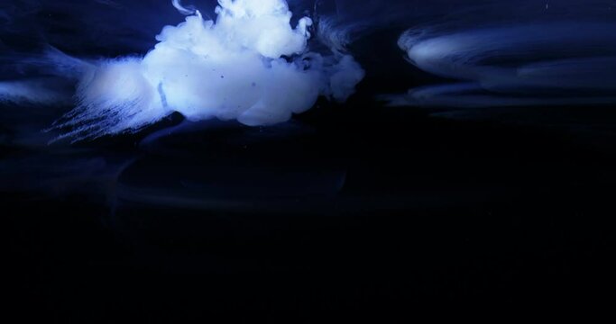 Blue / White ink / paint cloud in water tank with high speed camera