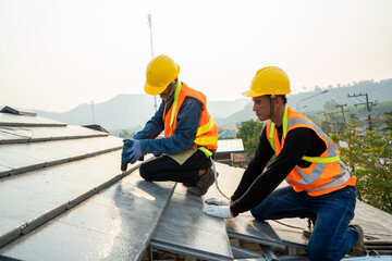 Professional technician roof install new roof on the roof top,Roofing tools,Hold the drive screw tool in hand. © visoot
