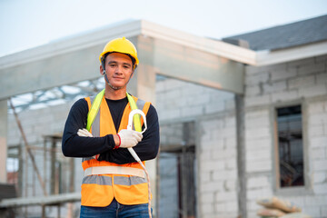 Portrait of construction worker on building site,Construction worker with hard hat working in new house.