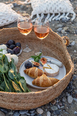 Summertime concept. Outdoor picnic with wine and croissants