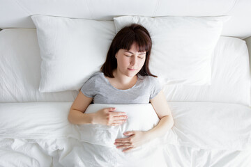 top view of young woman sleeping at home