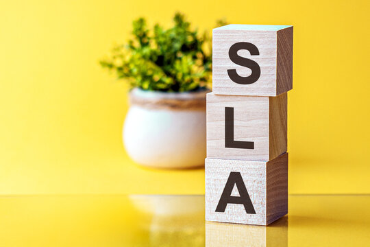 cubes with acronym SLA for service level agreement on a yellow background