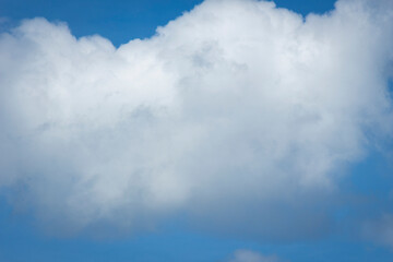 White clouds in blue sky background.