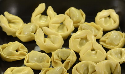 Italian traditional tortellini pasta or ravioli stuffed with spinach isolated on white background.