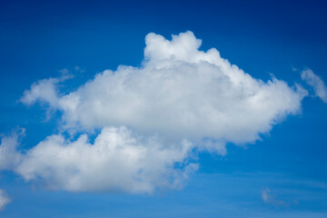 White clouds in blue sky background.
