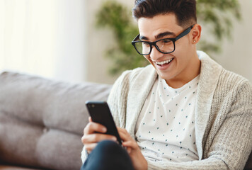 Shocked cheerful guy reading message on smartphone.