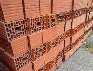 Wall blocks made from red porous ceramics with rectangular holes on a pallet