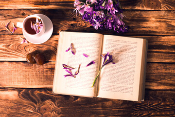 coffee book and flowers in a wooden background