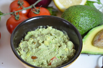 Girl make a sandwich Guacamole and bread. Toast with avocado on white background. Homemade Mexican healthy vegan food