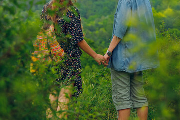 Fototapeta na wymiar hipster couple of boyfriend and girlfriend hold hands in park outdoor summer nature environment
