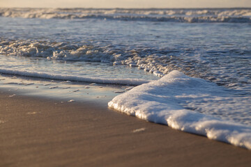sea waves at sunset in the north sea in the Netherlands