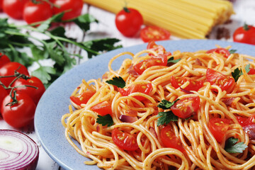 A plate with spaghetti with tomatoes	