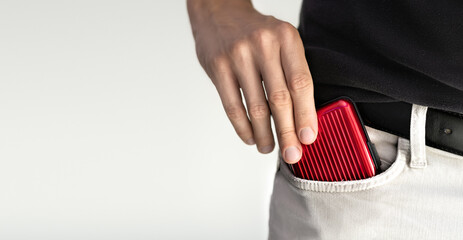 Man holding wallet for credit cards with RFID and NFC protection for contactless cards.