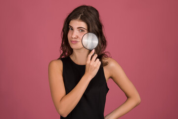 Fototapeta premium Young girl u with having skin problems. holding magnifier face skin close up