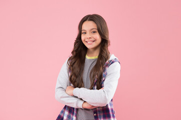 Obraz premium Confidence looks gorgeous on her. Confident kid keep arms crossed pink background. Confident look of fashion girl. Casual fashion trend. Trendy childrens wear. Kids wardrobe. Confident beauty