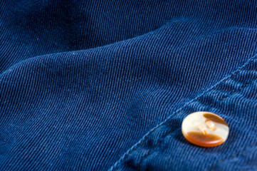 clothing items stonewashed cotton fabric texture with seams, clasps, buttons and rivets, macro