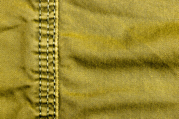 clothing items stonewashed cotton fabric texture with seams, clasps, buttons and rivets, macro