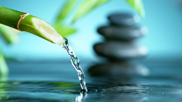 Super slow motion of leaking water stream from bamboo, spa and wellness concept. Filmed on very high speed cinema camera, 1000 fps.