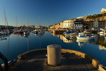 Jersey, U.K. August 4th 2020, Summer evening calm high tide at the 19th century English harbour of...