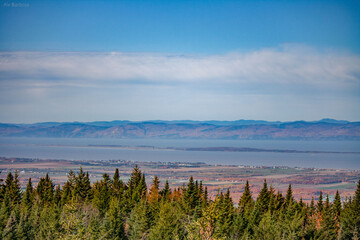 beautiful scenery, autumn in Canada, yellow trees, oranges, greens, sky, a beautiful lake and houses