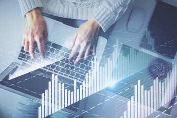 Multi exposure of woman hands working on computer and forex chart hologram drawing. Top View. Financial analysis concept.