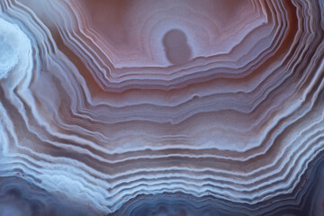 Full screen texture of striped agate colored by inclusions of red hematite