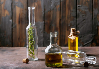 Obraz na płótnie Canvas Olive oil with rosemary in glass bottles