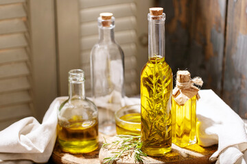 Olive oil with rosemary in glass bottles