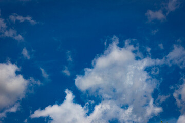 White clouds in blue sky background.