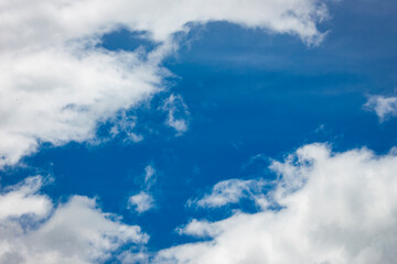 White clouds in blue sky background.