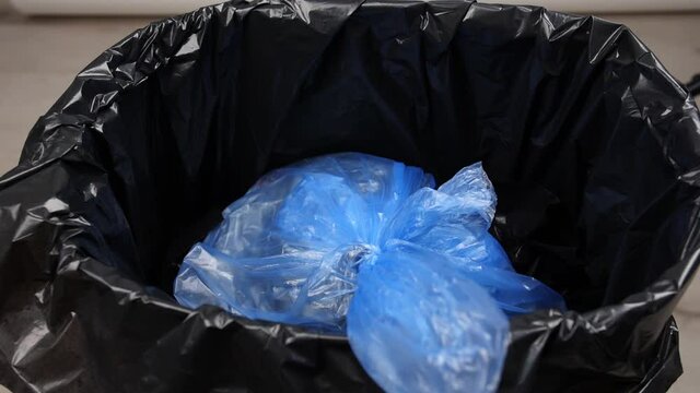 Throwing of garbage in trash bin, closeup