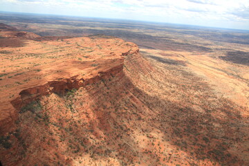 Fototapeta na wymiar An incredible aerial view over the dry desert landscape of George Gills Range and Kings Canyon, Northern Territory, Australia