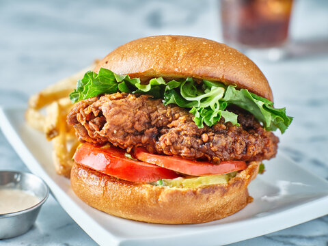 Crispy Fried Chicken Sandwich On Brioche Bun With French Fries