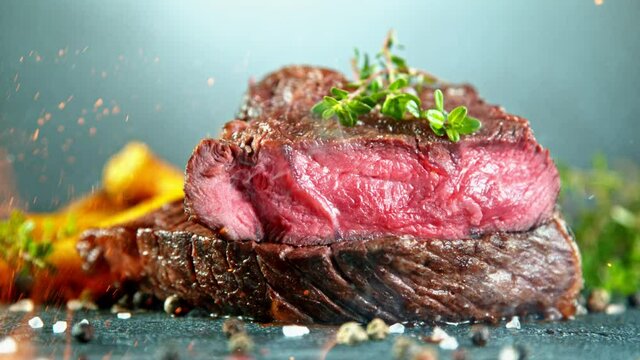 Close-up of falling tasty beef steak, super slow motion, filmed on high speed cinematic camera at 1000 fps.