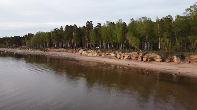 Red sandstone cliffs at Baltic sea coast Veczemju klintis aerial view