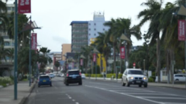 Cars And Taxi Driving At The Suva City With High Rise Buildings On The Background In Suva, Fiji - blurred