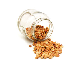 Peanuts in bottle with heap in front isolated on white backgroun