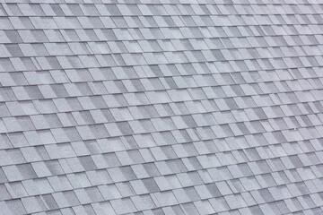 Installation of roof asphalt shingles. Bitumen roof shingles texture.