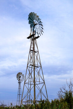 Three windmills on a country farm.