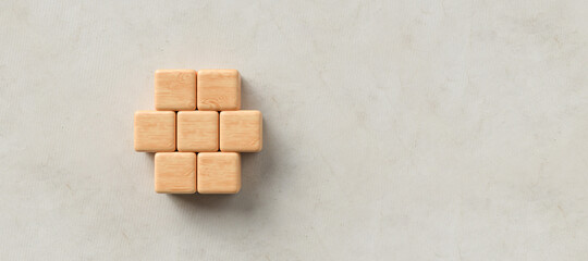 empty wooden cubes in the shape of a hexagon for own messages and icons on paper background