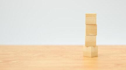 empty wooden cubes for own messages and icons on wooden floor and white background